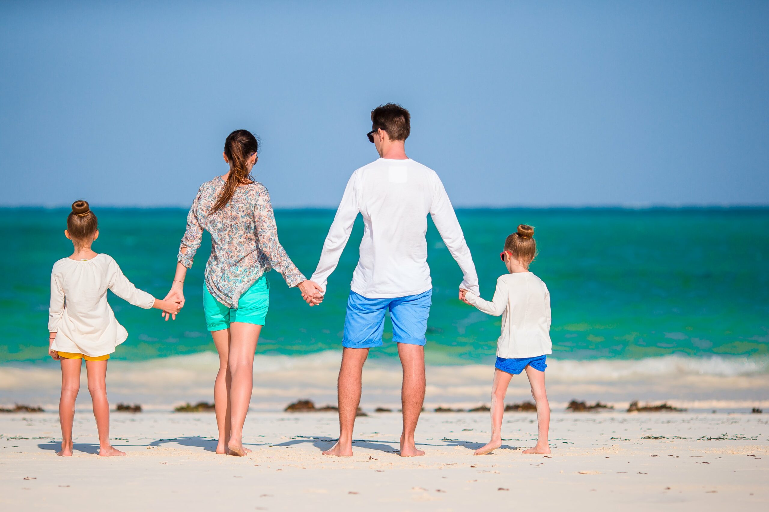 happy-beautiful-family-of-four-on-the-beach