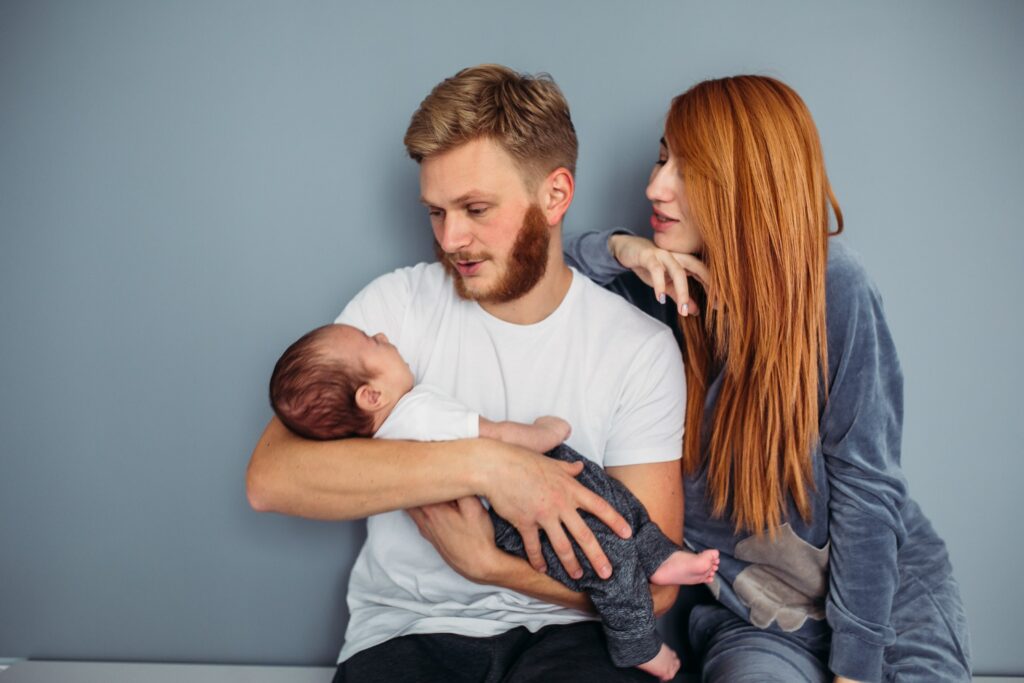 happy couple holding their baby