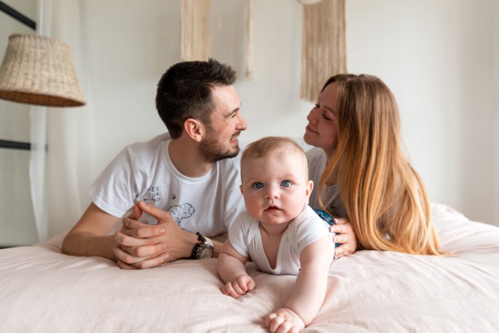 happy-family-mother-father-and-daughter-on-a-bed