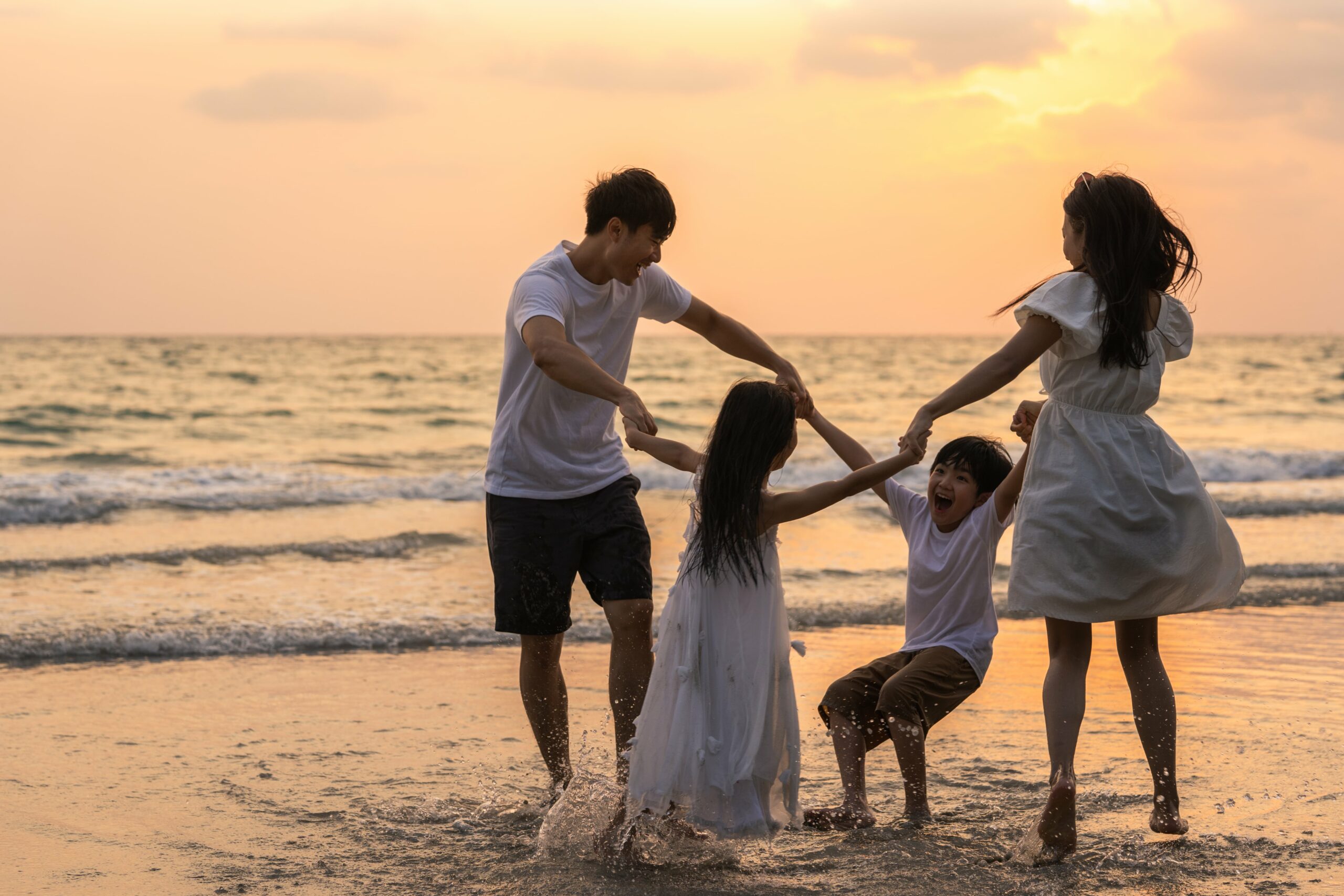asian-young-happy-family-enjoy-vacation-on-beach