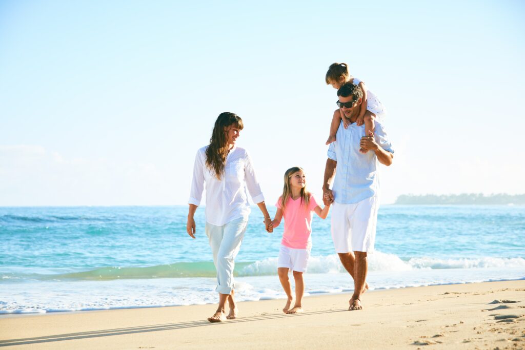 happy family walking on the beach