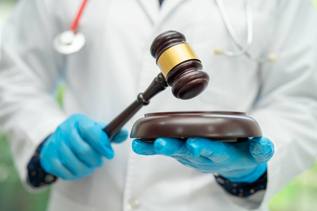 doctor-holding-judge-gavel-forensic-medicine-me